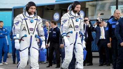 Alexey Ovchinin and Nick Hague make their way to the launch. EPA