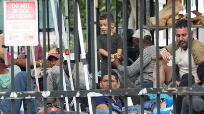Recently arrived migrants wait in a garage area of the U. S. Customs and Border Protection - Marathon Border Patrol Station, Wednesday, Jan. 4, 2023, in Marathon, Fla. More than 500 Cuban immigrants have come ashore in the Florida Keys since the weekend, the latest in a large and increasing number who are fleeing the communist island. (AP Photo / Wilfredo Lee)