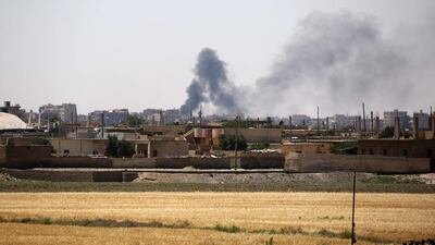 Smoke rises from buildings in the Al Meshleb neighbourhood of Raqqa on June 7, 2017, two days after the Syrian Democratic Forces entered ISIL’s Syrian bastion from the east. Delil Souleiman / AFP
