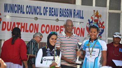 Najla Al Jeraiwi, left, draws attention with her scarf while competing, and was the first of three sisters to take up the sport. Courtesy Najla Al Jeraiwi