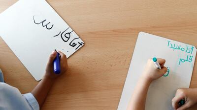 Pupils practise writing Arabic text at Kings' school in Dubai. Antonie Robertson / The National
