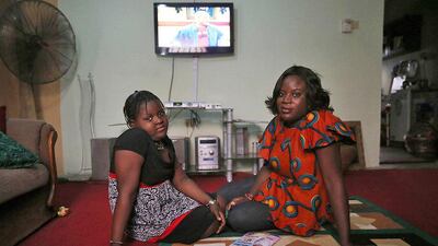 Adetola Ibitoye, 39, sits with her daughter Iteoluwa Ibitoye, 9, in their home in Omole district, Lagos. When Adetola was growing up, she wanted to run a fashion business. Now she is a clothes designer. Adetola says she wants her daughter to be the best at whatever she sets her mind to. Her daughter Iteoluwa wants to become a university teacher. Akintunde Akinleye / Reuters