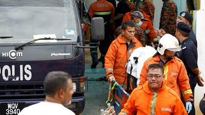 Firefighters leave religious school Darul Quran Ittifaqiyah after a fire broke out in Kuala Lumpur, Malaysia. Lai Seng Sin / Reuters