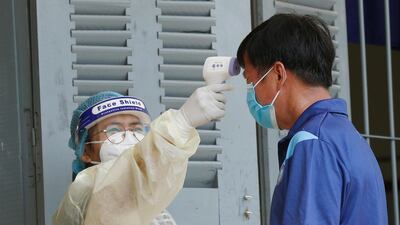A man has his temperature checked during a vaccination drive held in Phnom Penh, Cambodia. EPA