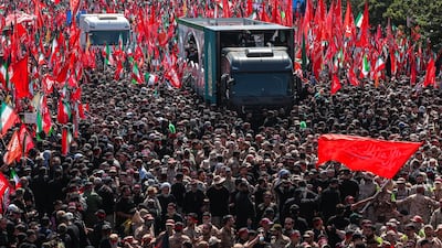 Crowds surround a vehicle carrying the coffins of Iran's late supreme leader Ayatollah Ali Khamenei and his family members through Tehran on Monday. Office of the Iranian Supreme Leader via Reuters