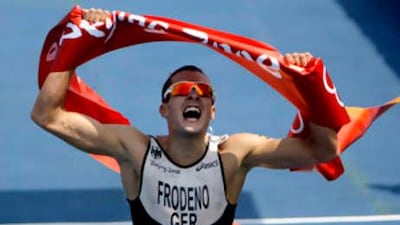German Jan Frodeno crosses the finish line to win the gold medal in the men's triathlon.