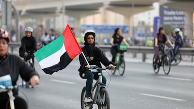 A participant takes part flying the UAE flag