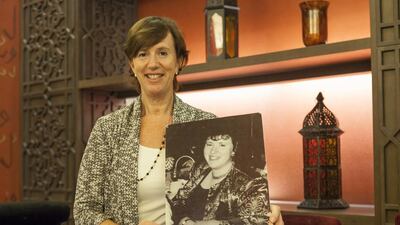 Carole Holditch poses with a photograph of herself before she lost 19kg with the help of a support group. Antonie Robertson / The National
