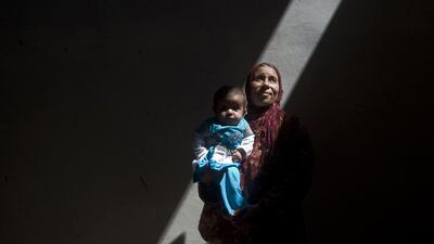 Amina, a Syrian woman who fled fighting in Aleppo, takes shelter inside an abandoned building with her sick five-month-old daughter, Asma, on the outskirts of Saraqib, southwest of Aleppo. Giovanni Diffidenti / AFP