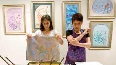 Ayla Makas, right, and her apprentice Ayse Saricam, both of Istanbul, demonstrate the Turkish art of ebru print making.