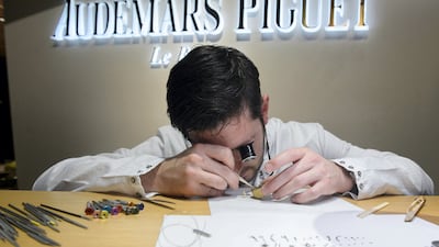 An employee of Swiss watchmaker Audemars Piguet checks a wristwatch. The company generated just over two billion Swiss francs in sales in 2022. AFP