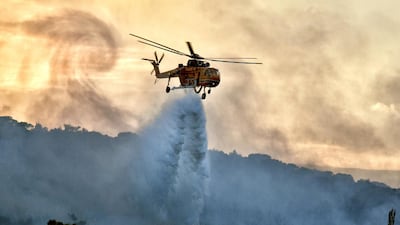 A helicopter is used to extinguish a wildfire in Agioi Theodoroi, outside of Corinthe city, Peloponnese, southern Greece, 10 July 2019 EPA