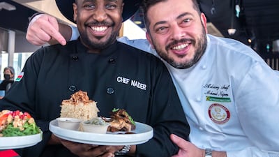Chef Nader Al Aisari (centre) was one of many regional chefs to cook at Expo 2020 Dubai. Seen here with Qatar's Mohammad Najem. Victor Besa / The National