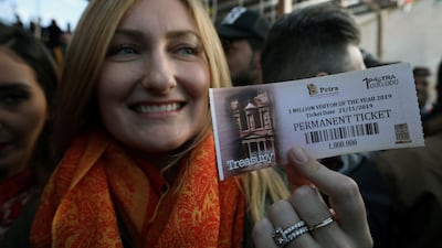 American tourist Allison Carey holds the one millionth ticket. Reuters