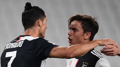 Juventus' Argentine forward Paulo Dybala (R) celebrates with Cristiano Ronaldo after opening the scoring. AFP