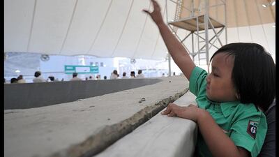 A child throws a pebble at pillars during the stoning of Sata, the 'Jamarat' ritual, near the holy city of Mecca. Fayez Nureldine / AFP