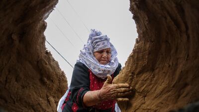 Palestinian Latifa Al Najjar makes clay ovens to be sold in Khan Yunis in the southern Gaza Strip. AFP