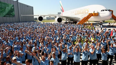 Workers celebrate beside the Airbus A380 in 2008 in Hamburg, Germany. The world's largest passenger jetliner was to be delivered to Emirates airline. Getty Images