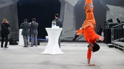 An artist warms up in front of a projection of the North entrance of the new Gotthard Base Tunnel in Switzerland. Fabrice Coffrini / AFP Photo