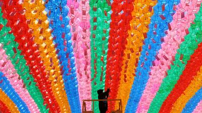 A worker attaches a name tag of a Buddhist who made donation to a lantern for the upcoming celebration of Buddha's birthday at the Jogye temple in Seoul, South Korea. AP Photo
