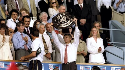 Arsene Wenger lifts the Charity Shield after Arsenal beat Manchester United at Wembley on August 1, 1999. Getty