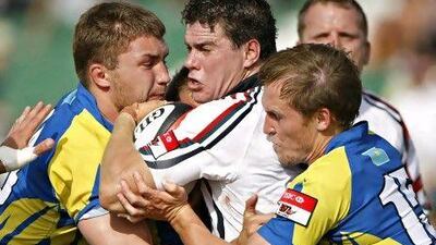 Kazakhstan defenders tackle the UAE's Patrick Hegarty.