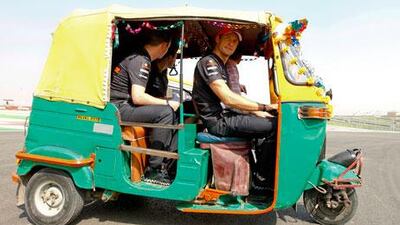 Jenson Button, the McLaren-Mercedes driver, right, has a bit of fun driving an auto rickshaw at the Buddh International Circuit, in Greater Noida, on Thursday. Button is second in the driver’s standings.