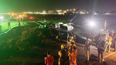 Investigators look on a burnt Lion Air aircraft at Manila's international airport. EPA