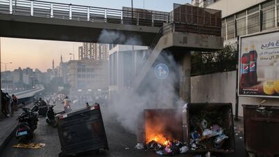 Anti-government protesters burn bins to block a highway that leads to the airport during a protest near Beirut. EPA