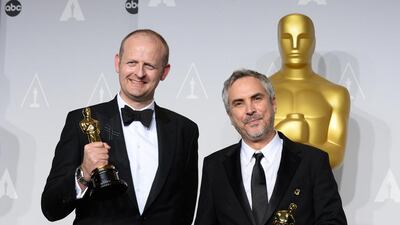 Alfonso Cuaron, right, and Mark Sanger pose in the press room with the award for best film editing for Gravity during the Oscars at the Dolby Theatre on March 2, 2014, in Los Angeles. Jordan Strauss / Invision / AP