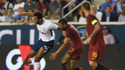 Mousa Dembele, left, of Tottenham Hotspur fights for the ball with Aleksandar Kolarov, centre, and Daniele De Rossi of Roma. Don Emmert / AFP