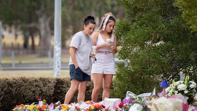 Two women stand at a floral tribute to murdered Israeli student Aiia Maasarwe in Melbourne on January 18, 2019. AAP Image via AP)