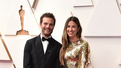 Jamie Dornan and Amelia Warner, wearing gold Giambattista Valli. AP