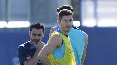 Robert Lewandoski and manager Xavi Hernandez during training. EPA