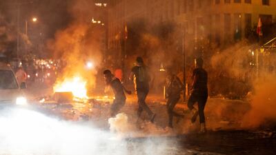 Riot police fired tear gas to disperse demonstrators. AP