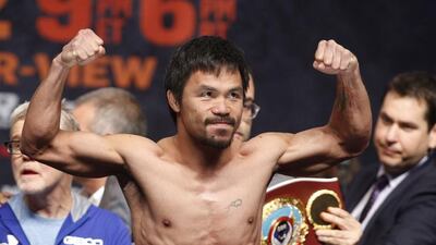 Manny Pacquiao gestures while standing on the scale for the weigh-in on May 1, 2015 in Las Vegas, Nevada one day before their "Fight of the Century" on May 2 at the MGM Grand Garden Arena. AFP PHOTO / JOHN GURZINSKI
