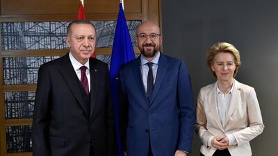EU Council President Charles Michel (C) and European Commission President Ursula von der Leyen (R) pose with Turkish President Erdogan (L) before their meeting in Brussels. Reuters