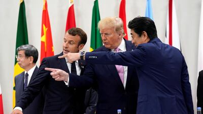 France's Macron, Trump and Abe gesture together during a meeting. Reuters