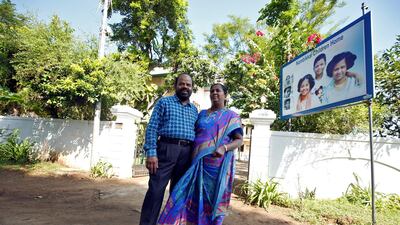 Karibeeran Paramesvaran and his wife Choodamani, who lost three children in the 2004 tsunami, pose outside their house that they have turned into a care home for orphaned children in Nagapattinam district in the southern state of Tamil Nadu, India. REUTERS