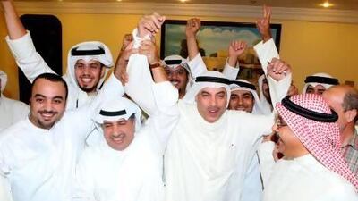 Faisal Al Shayaa, centre, celebrates with his supporters following his victory in the parliamentary elections in Kuwait City. Yasser Al Zayyat / AFP