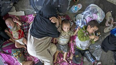 Suspected Uighurs rest inside a temporary shelter after they were detained at the immigration regional headquarters near Thailand-Malaysia border in Hat Yai, Thailand. Athit Perawongmetha / Reuters / March 14, 2014