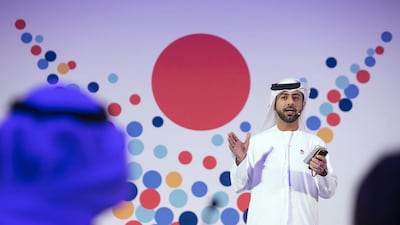 Ahmed Al Blooshi, 33, presents the Aman medical wristband at the Emirates Award for the Arabian Gulf Youth presentation yesterday at Jumeirah Etihad Towers. Below, Mr Al Blooshi with teammates Intesar Al Hajri, 25, and Maha Al Dhaheri, 20. Photos Silvia Razgova / The National