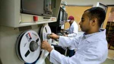 An ADMC technician with one of the digital archiving machines, that will be used to transfer thousands of hours of UAE history from film to electronic format.