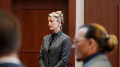 Heard and Depp watch as the jury comes into the courtroom. AP