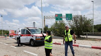 Emergency personnel survey the site of the missile attack. Reuters