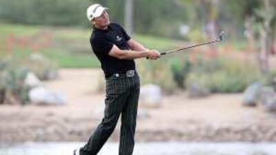 Jarmo Sandelin of Sweden plays his second shot at the 9th hole during the first round at the Abu Dhabi Golf Club on a chilly Thursday afternoon.