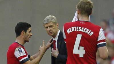 Arsenal midfielder Mikel Arteta, left, gestures to Arsenal manager Arsene Wenger during the English FA Cup Semi-final match between Wigan Athletic and Arsenal at Wembley Stadium in London on April 12, 2014. AFP PHOTO/IAN KINGTON