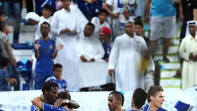 Ibrahima Toure, left, of Al Nasr celebrates with his teammates after scoring a goal against Al Ain during their President's Cup match at the Al Maktoum Stadium in Dubai on Saturday. Satish Kumar / The National