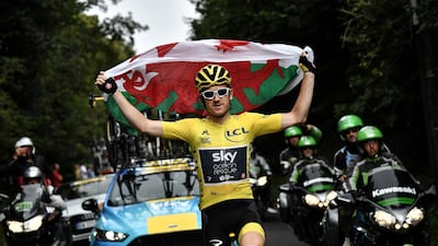 Thomas holds the Welsh flag. Reuters