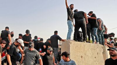 Supporters of the Shiite Co-ordination Framework take part in a counter-protest against Al Sadr loyalists outside the Green Zone. AFP